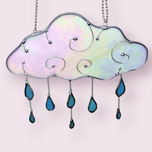 Rain Cloud Suncatcher - Sugar & Spice Crafts. Front view of hanging rain cloud and dangling blue drops. The cloud has wire swirls and iridescent glass.