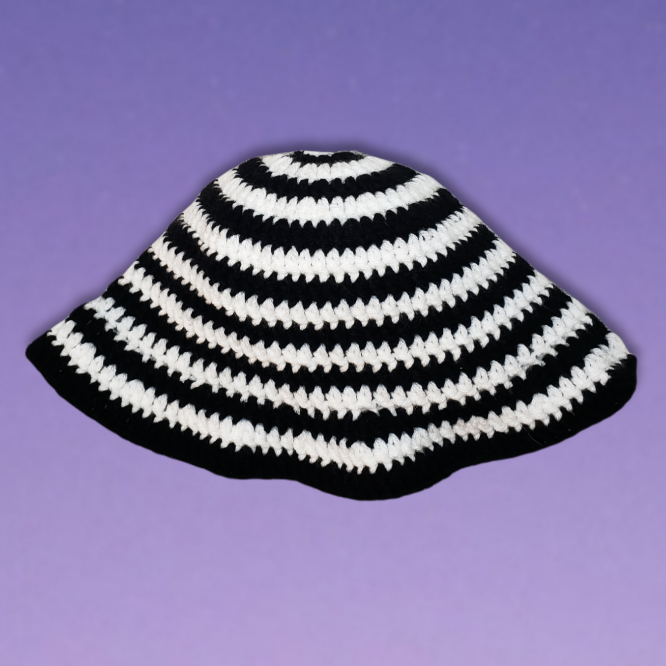 Black and white spiral crochet bucket hat in flat lay